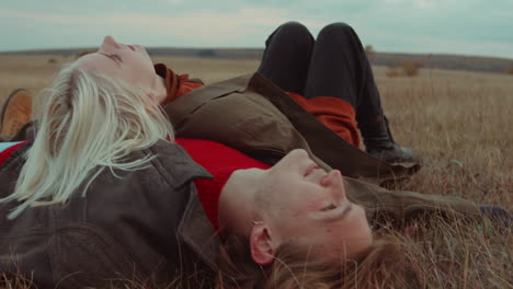 Woman-Falling-Down-and-Lying-with-Boyfriend-on-Autumn-Field